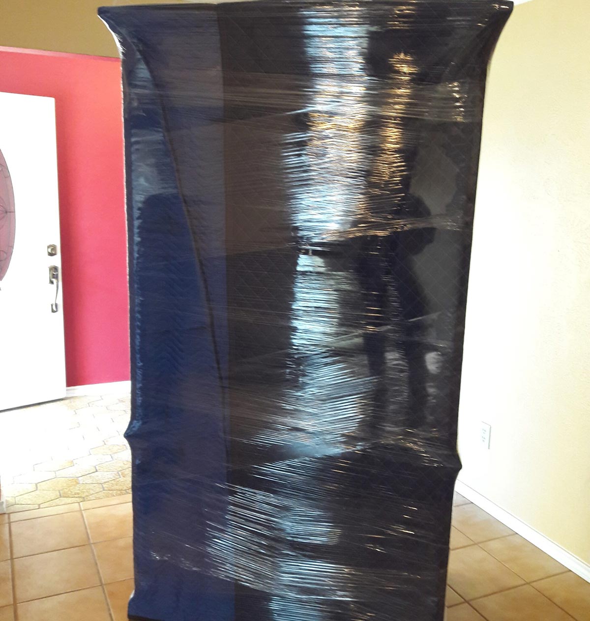 carefully wrapped armoire by a professional mover